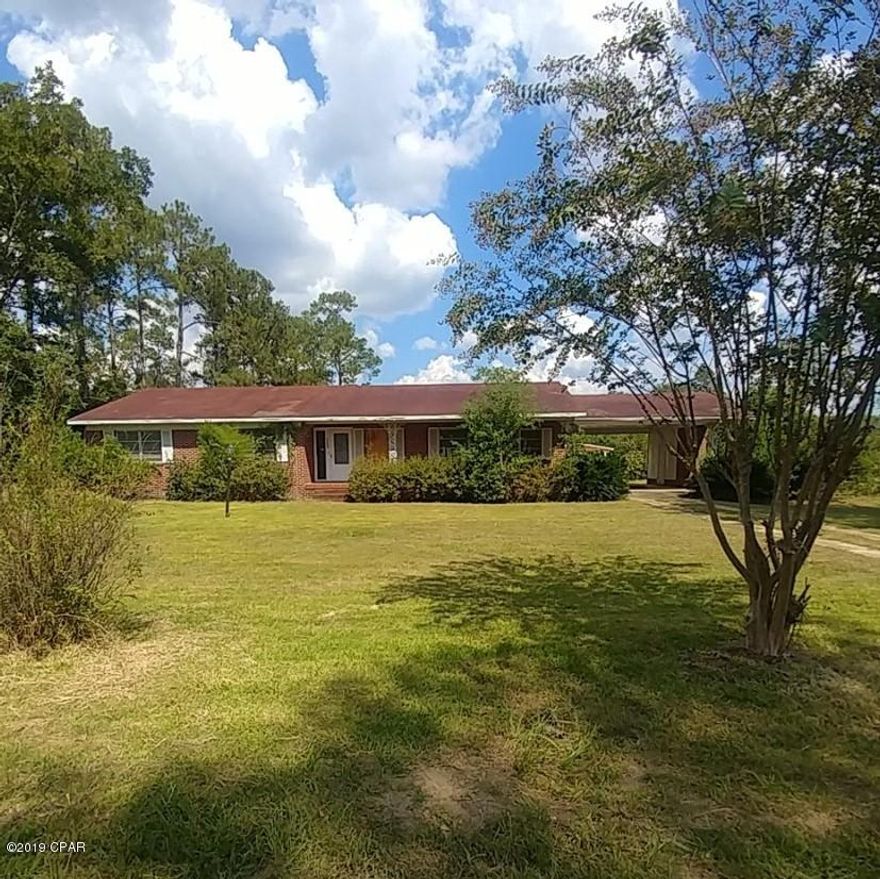 Large 3-bedroom, 2-bath brick home located on a paved corner lot in Graceville, Florida.  Nice kitchen with breakfast bar and a lot of cabinet space and has a formal dining room, as well.  Large family room with built-in bookcases.  Nice foyer area that opens up into the living room.  Master suite has a large bathroom with separate dressing area.  Nice screened porch on the back with custom flooring.  There is an attached 20'X34' carport and a separate storage room with it's own attic space for additional storage.  Metal shed (12x16) in backyard.  Close to Baptist College and in close proximity to shopping.  Approximately 22 miles/30 minutes to Dothan, AL.