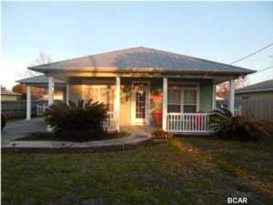 Ride a bike or golf cart to the beach in just a few minutes! Charming 2 bedroom/2 bath cottage perfectly situated between the beach and Back Beach Road. Each bedroom opens onto large screened back porch and everything is on one floor for easy living. Living/dining area is separated from kitchen by hanging glass cabinets. Metal roof, concrete driveway, and hardiboard type siding for easy maintenance. Granite counter tops in the kitchen with both dining area and a breakfast bar. Lots of windows and full of light, and carport with storage room for beach toys, bicycles, and miscellaneous. Large lot with fenced back yard for privacy. Washer and dryer, refrigerator, convey with sale. Both porches large enough to entertain or accommodate large table for meals. Approximately one-half mile