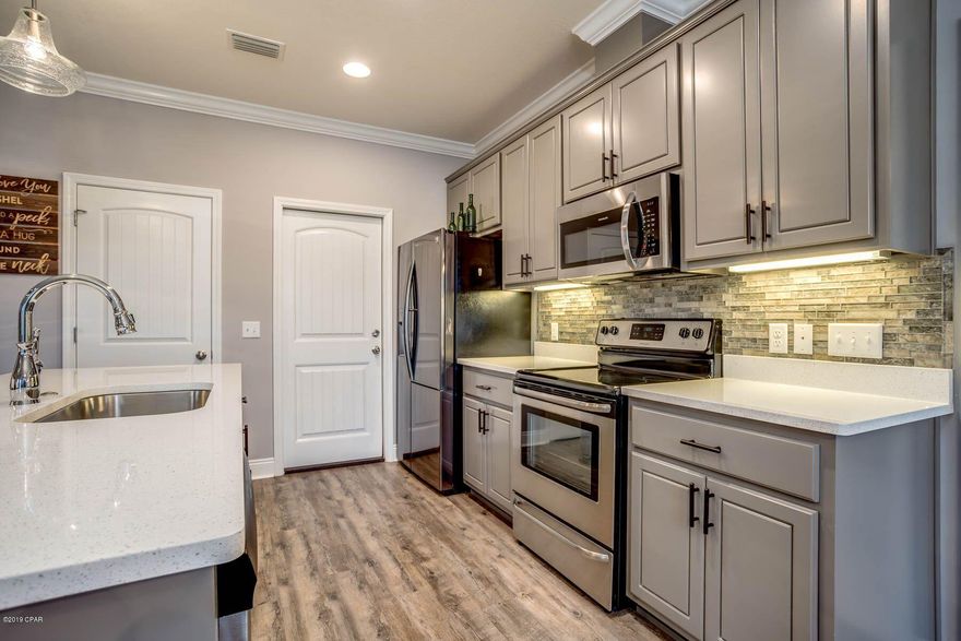 Once you drive up, you will notice the fully landscaped yards, with sprinkler system as it is picture perfect.   As you step in this craftsman style house in Cedar Park, you will see numerous upgrades to include glass front storm door,   9 ft ceilings with step ups, upgraded light fixtures, gray tone paint with custom cabinets complete with quartz counter tops, island, and stainless steel appliances.  The lighting includes recessed lighting, wainscoting and tile flooring,, laminate and carpet.  The master bath features double closets and designer cabinets featuring two vanity bowls and designer mirrors.  As you walk out the back door you will enjoy the extended living on the screened porch and the paver patio.  What a perfect place to relax in your private backyard.   New roof installed after the storm.  Survey on file.  Call to tour this house today as it won't last long.  All information contained herein is believed to be accurate and true, however it is the buyer's responsibility to verify.