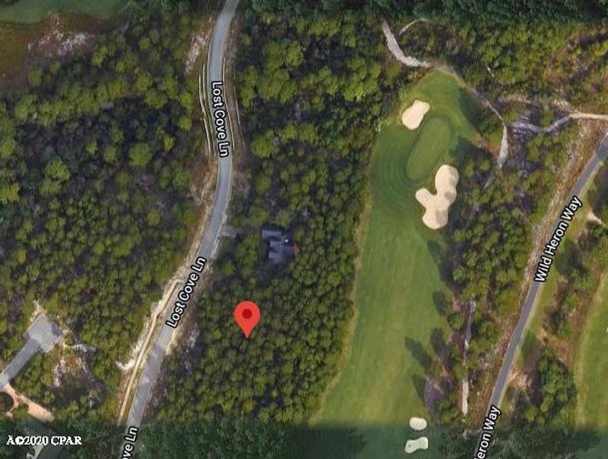 Nestled directly on the 10th hole of the Greg Norman designed, Sharks Tooth golf course in Wild Heron, this homesite features gorgeous mature trees and is one of the highest points in the entire community. Build here and enjoy wonderful views of the golf course and all of Wild Heron's exclusive amenities. Owners enjoy  a pool, hot tub and fitness center...all on lakeside overlooking Lake Powell. Also lakeside is a fire pit, owner's library, boardwalk and community dock. Kids can play on the playground behind the event green and of course there is world-class golf. If you are serious about building in a beautiful community, be sure and look at this site today.