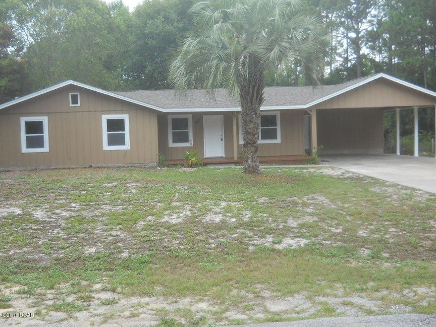 Seller Motivated! TOTALLY RENOVATED 3 Bedroom home on quiet cul-de-sac street on desirable West end of Panama City Beach.  This home sits on a huge DOUBLE lot and features beautifully refinished bamboo floors in living room, hall and dining area, new carpet in bedrooms,new appliances and off the kitchen you have a  large 8'by 17'laundry room you can also access from back yard.  Outside your back door you have a screen-in porch,an outbuilding that would be perfect for an office, workshop or ''mancave'' and new roof on house and workshop. The lot is shaded with lots of trees.  Great Location - less than a mile to the beach, close proximity to shopping, dining and entertainment and just a 15 minute drive to the airport. Seller offering a 1 year home warranty! This one won't last long! All information is taken from public records. If important to buyer, please verify. Listing Broker has ownership interest in property