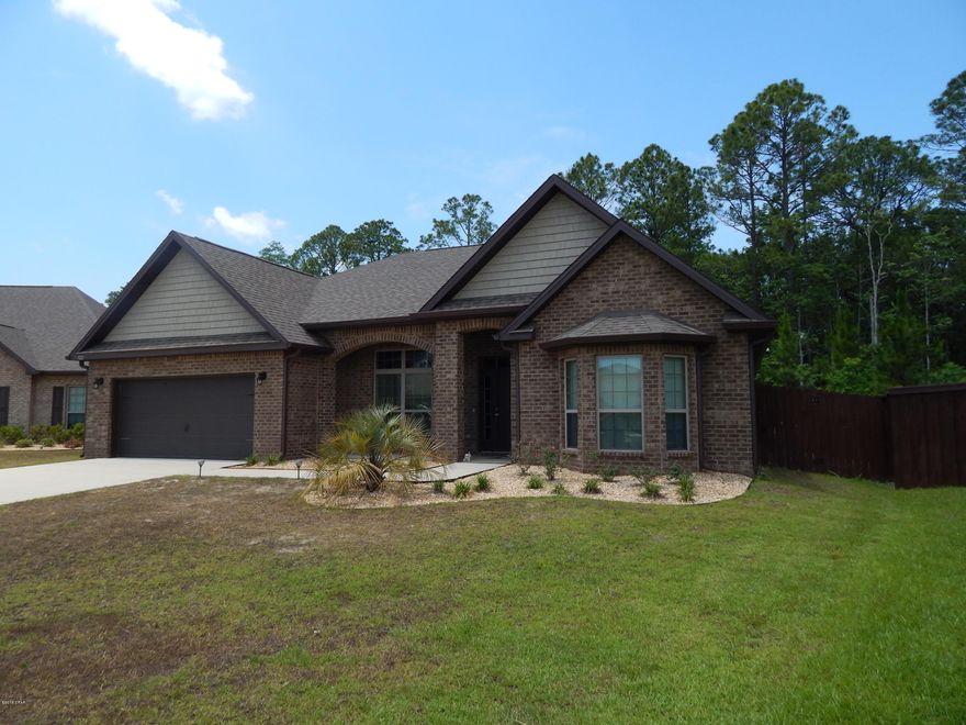 Spacious Brick home, better than new with builder upgrades, the seller added plantation blinds throughout, privacy fencing, gutters and more.  This is a beautiful 3 BR, 2BA home plus a spacious office closed off with French doors. From the attractive double trey ceiling in the family room, to the several arches,crown molding, and wood floors, this home is over the top. The master bath has a garden tub, separate shower, water closet and double vanity and there is also  a sitting area off bedroom. Owner has taken a great deal of pride in the home and it is move in ready.  The location is great, within walking distance of Tommy Smith Elementary and Merritt Brown Middle Schools and close to Hwy 231 and Star Ave.giving easy access to both Tyndall AFB and Panama City.