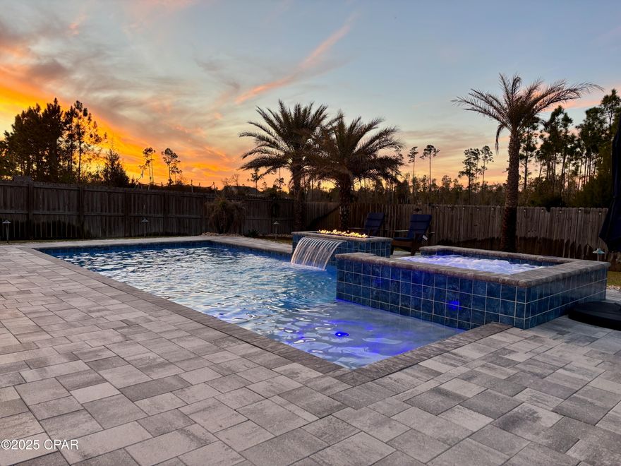 Welcome to your dream retreat! This beautifully maintained 3-bedroom, 2-bathroom home is tucked away on a quiet cul-de-sac in one of Panama City's most desirable neighborhoods. Built in 2017, this residence combines modern comfort with high-end touches throughout. Step inside to a spacious open-concept floor plan featuring elegant vinyl plank flooring, 9-foot ceilings, and stunning tray ceilings that add a touch of sophistication. The oversized guest bedroom provides plenty of space for visitors or a comfortable home office setup.The kitchen and living area flow seamlessly for entertaining, while large windows invite in natural light and offer views of your private backyard oasis. Out back, you'll find your own resort-style escape—a sparkling pool with an attached hot tub, surrounded by a beautifully landscaped patio, complete with a fire feature for those cozy Florida evenings.With both form and function, this home offers exceptional curb appeal, energy efficiency, and a tranquil setting that's still convenient to shopping, dining, and local schools.