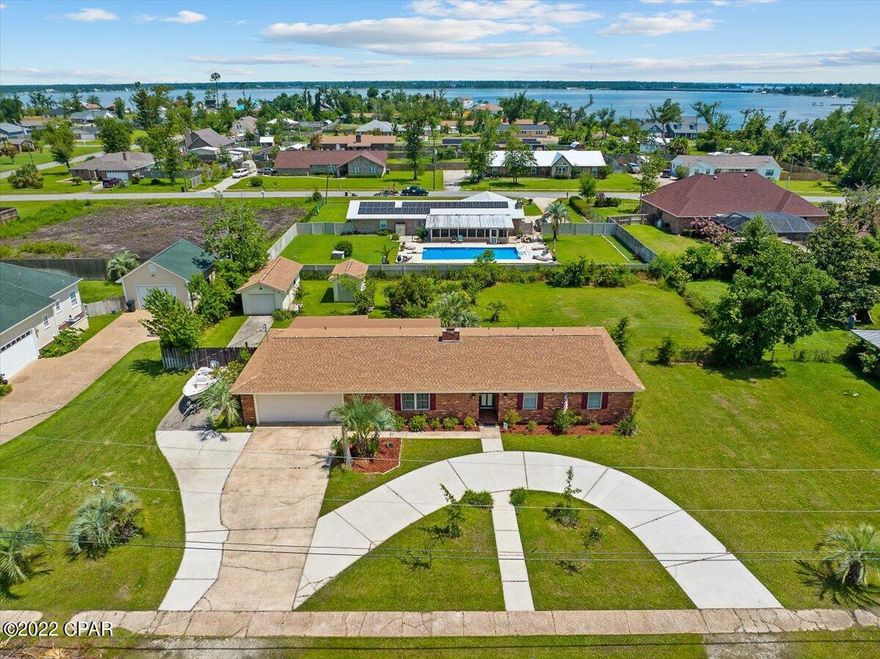 CURRENTLY UNDER CONTRACT, SELLER WILL CONSIDER BACKUP OFFERS. This 3 bedroom 3 full bath home features family room, formal living and dining room, large open kitchen, cozy Florida room, covered patio and a backyard that has so much to offer including a 26 x 12 workshop. The home features beautiful wood beams and brick fireplace and all of the bedrooms are spacious. The master bedroom has a large walk-in closet. The kitchen overlooks the Florida room and backyard and features large pantry, lots of cabinet space, and breakfast bar. There is a lot of storage in this home.  Outside, there is a circular drive-way, additional parking for a boat or RV with a double-gate on one side and a large 26 x 12 shop in the backyard. The shop has electricity and a window A/C. There is also another storage shed perfect for lawn equipment.  The yard is perfect for gardening and planting and there is already a lot of established landscaping and over a 1/2 acre to work with.  This home is one block from the Bay and you can see the Bayou from the front yard. This location is just minutes to two different public parks and North Bay drive is perfect for walking, riding bikes and enjoying the peacefulness of College Point. This home has a new septic system (installed Jan 2021) and a brand new roof after Hurricane Michael. THIS HOUSE IS NOT IN A FLOOD ZONE