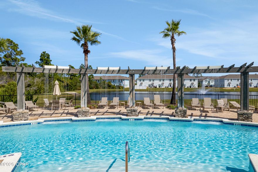 END UNIT | 
BONUS SLEEPING SPACE | WEEKLY RENTALS ALLOWED | 1877 Pointe Drive in the Hathaway Townhomes community offers a three-bedroom townhome layout plus a spacious bonus sleeping area created from the converted garage. This additional room includes its own mini-split HVAC system and provides flexible space that can function as a guest room, office, media room, or additional sleeping area. The main living area features an open floor plan connecting the living room and kitchen, creating an easy flow for everyday living and hosting guests. The kitchen includes granite countertops, stainless-steel appliances, and generous cabinet storage. Luxury vinyl plank flooring runs throughout the first floor, while the second-floor bedrooms feature carpet. As an end unit, the home benefits from additional side windows that bring in natural light and create a brighter, more open feel compared to interior units. Hathaway Townhomes allows weekly rentals, providing flexibility for owners considering personal use, long-term rental, or short-term rental opportunities depending on current regulations and management preferences. The additional sleeping space can also help maximize occupancy potential. Located on the Panama City Beach side of the Hathaway Bridge, Hathaway Townhomes provides convenient access to both Panama City and the beaches of the Gulf Coast. Community amenities include a swimming pool and HOA services that cover exterior insurance, grounds keeping, trash service, and maintenance of the common areas. 
HOA fees are $399.70/month. All information and HOA fees are deemed accurate but should be verified by buyers if important.