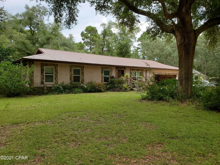Check out this WELL-BUILT home close to Lakes LUCAS (1 mi), HICKS, DUNFORD & STEWART. Drive-thru boat house 23x16 & 2-rm MIL suite wannabe 23x16. Nearly surrounded by woods. HVAC & 400' well within past 5 yrs. New metal roof since Michael. High-gauge hurricane impact shutters. Hurricane Impact windows. Hard wood/tile floors, fireplace (was wood, now gas or electric), gas stove. 2-CAR GARAGE! Plenty of mature fruit trees, such as 2 satsumas, grapefruit, loquat, kumquat, fig & grapevines. You may never need to shop for groceries again! Close to Vernon schools, Chipley, PC, PCB, Pier Park, & NW FL Beaches Airport, plus tons of lakes & recreational springs. DISH & Direct TV avail., I'm told. Come on, y'all!