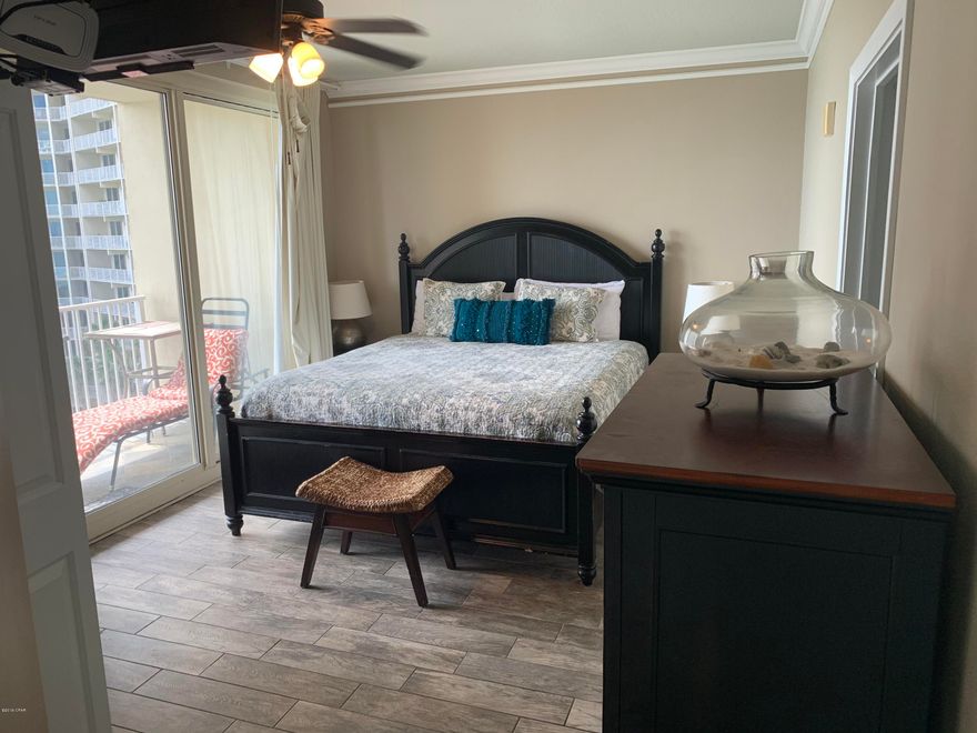 Rare coveted lower floor ''L'' unit that is beautifully furnished with lots of upgrades. This is arguable the best 2-bedroom floorplan in the building.  Seller had upgraded tile, carpet, light fixtures, glass tile backsplash in kitchen, double crown molding, deluxe washer/dryer. So many upgrades and the ''L'' floorplan is the only unit that the master has a slider door to the balcony overlooking the gulf. It has a double balcony with slate tile.  This bedroom feels like a 3 bedroom because the bunk room in enclosed but has no closet, so it doesn't technically qualify as a bedroom.  This condo comes with a deeded parking spot.