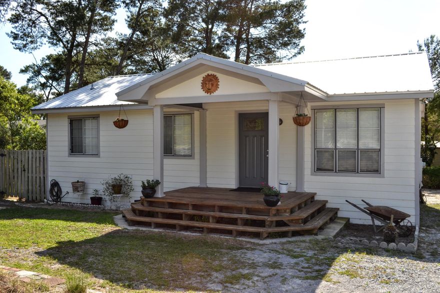 Whether you are looking for a vacation beach home, starter home or a place to spend retirement, this adorable two bedroom, two bath Florida Cottage located in Inlet Beach is more than worth a look. You will be drawn in immediately by this home's curb appeal and charm. Updated with ash wood flooring, granite kitchen counter tops, tile flooring and marble counter tops in both bathrooms. The roof was replaced in 2013. If you enjoy an active outdoor life, you will appreciate that this home is located just 2.3 miles from Camp Helen. The nearest beach access is just 2800 feet away complete with bike racks and clean restrooms. You are just 3 miles from Camp Creek Golf Club and if that isn't enough enticement, just 0.6 miles away is the ever popular Donut Hole!  You will enjoy entertaining on the covered deck which runs the length of the home. Both the covered deck and open decks along the side allow you to carry gatherings outside and give the home a larger feel. The yard is completely fenced with enough room for a future inground pool.  Parking is no problem with the circular drive in front and additional parking on the side.  You would also have room to bring your camper. There is even a shed to store all of your beach toys. Call your agent today to schedule an appointment.  All measurements, room sizes and ages are approximate. Please verify if important.