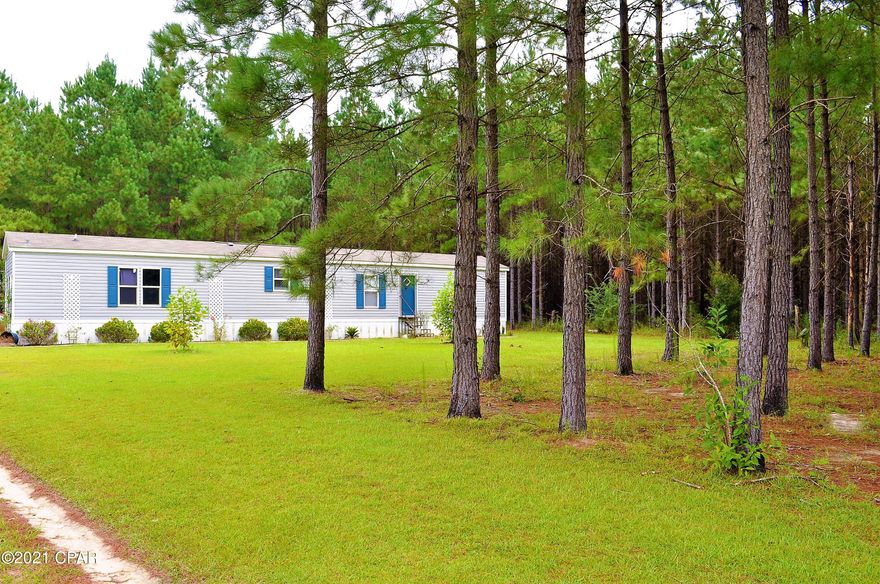 This beautiful property is nestled just outside of Chipley FL and set up with a beautiful landscape.  Perfect hunting and fishing getaway, this property has deer, turkeys and other wildlife gracing the grounds.  There's also a small lake on the property filled with some of Florida's finest gamefish.  The home is a beautiful 6 y/o singlewide with many upgrades to the home.  This property is a must see, must have.  Property also has a couple of acres of planted pines which should be ready to cut in about 6 years.  This property is a must see property.