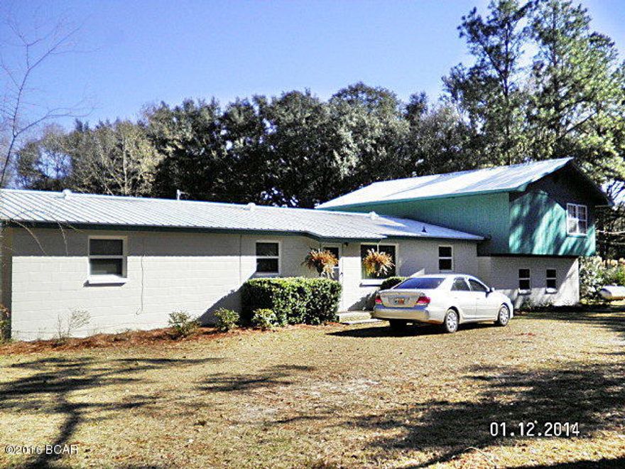 This large home has been completely remodeled, the main house is a 3/2.5 with tile and wood laminate, updated kitchen new paint,new drain-field installed in 2013 new well in 2005 (old well not capped would be good for irrigation) new metal roof in 2013, new wiring in 2006 new windows home and porch (Low E) in 2008 salt water solar heated in-ground pool with pool house. There is also a 1/1 with complete kitchen and and separate entrance for guest or rental unit. upstairs is a large open floor-plan nicely remodeled with a deck overlooking the pool. The complete property is fenced and the present owners have dogs. The pool is fenced, there is a nice sun-room with a view of the pool also, this home has a lot to offer and is just minutes from downtown, and a corner property. The carport will hold 3 cars easy with room for storage, there is water run to carport also, there are citrus and fruit plants, large oaks and natural woods with a wet weather pond on the property. This is a solid and well constructed home, call agent today to show this home.