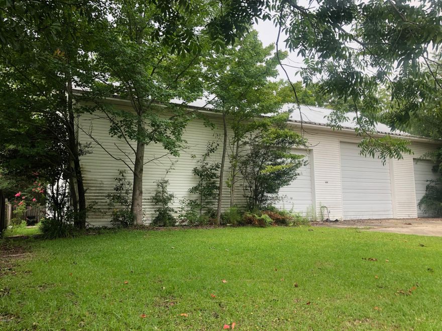 Apartment with 3 Bay Garage.  Here's a chance to live in and work next door.  Plenty of room to store your toys or more.  Nice pine floors in the apartment with oak cabinets.  The apartment will need some TLC but shows well. Comes with a large vacant lot to build your home on.