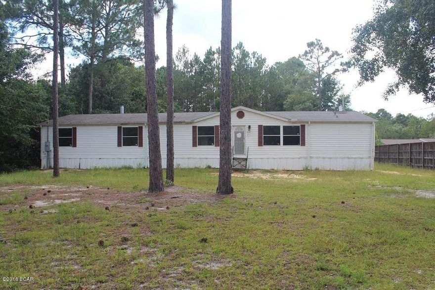 Large mobile home on a large one acre lot.  The property is located on a paved road and just on the outskirts of town.  Property has a large detached two car garage that would be perfect for a workshop.  The home has been a rental and is in need of some work such as flooring, painting, roof, etc.  Age and Room sizes are estimates.