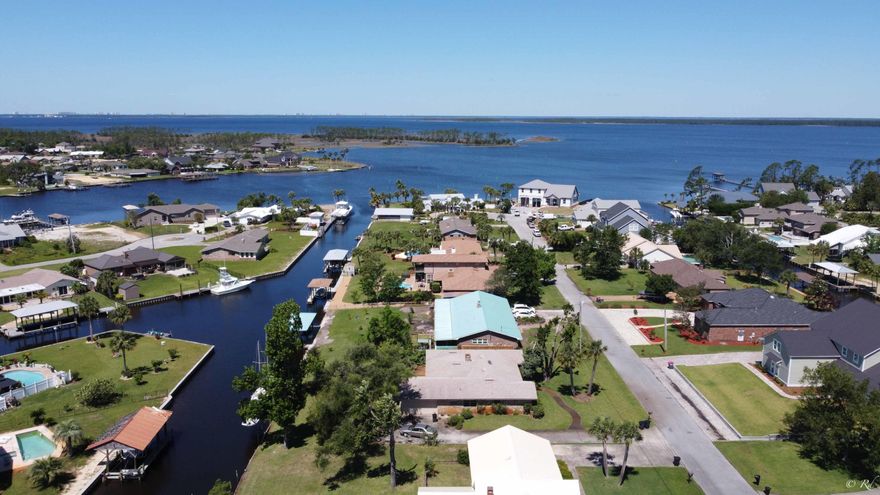 UNDER CONTRACT - ACCEPTING BACK UP OFFERS. Do you have a boat and want to simply step into your backyard to cruise to the Gulf?! Then look no farther because this deepwater canal front home in Northshore is ready for all your saltwater adventures. Big nice boat lift/house with large capacity and remote control operation, jet ski lift and composite decking all complimented with a sturdy 100' seawall. Spend your days on the dock watching the friendly marine life swim by and if you like fresh fruit you're all set with the variety of Florida fruit trees on the property. New roof, new sheetrock in garage/living area and new heavy duty garage door. Washer/Dryer & freezer in garage convey with the sale. This Lynn Haven home is a 4/2 with strong bones and tons of potential.  FEMA Flood Zone X