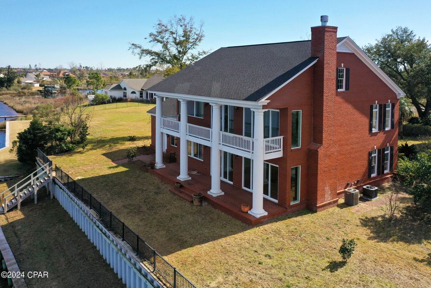 Stunning waterfront estate overlooking Beatty Bayou in much desired College Point area of Lynn Haven. Interior features include numerous custom built-in shelving units providing plenty of storage, gorgeous water views from the large windows throughout the house, large eat-in kitchen with custom cabinets, formal dining room, & a huge living room with built-ins and fireplace overlooking the bayou. Master suite on the 2nd floor has 2 sets of sliding glass doors opening up to the balcony. Master bath en suite has a double vanity, garden tub, separate shower, & his/hers walk-in closet. Jack-and-Jill bathroom connects the 2 additional bedrooms. Office on the main level includes a full bath & walk-in closet and could be used as a 4th bedroom.
Exterior features include an oversized garage with built in cabinets and shower with floor drain, sea wall, dock, almost half an acre lot.