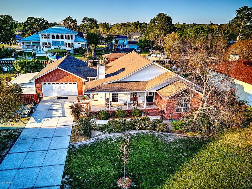 2202 Windjammer Dr, Lynn Haven Fl 32444 BUY ONE OR BUY BOTH PROPERTIES! This is truly a fishing and water lover's dream with captivating sunsets; endless possibilities....come and mastermind your IDEAL COASTAL LIVING DREAM! 

Just a few of the home's great features include granite counter tops, stainless appliances, hardwood floors, cultured marble vanities, vaulted ceilings, a large pantry, brand new gas fireplace, built in surround sound and a magnificent sunroom perfectly situated for enjoying sunsets. This home is on an elevated slab and constructed of brick with a lovely wrap-around front porch and beautiful paved courtyard in the back. The yard is nicely landscaped, has outdoor storage and workshop, and there is plenty of room to add a pool. Home includes a monitored security/fire system, sprinkler system on an irrigation meter, and air-conditioned garage. The conveniences and comforts were all well planned and laid out! 
This home is BEAUTIFUL AND MOVE-IN READY! Schedule your private showing today.
All measurements and sizes are approx. and should be verified. 

The lot which includes the home is located on the canal, has a dock with davit system that can be used for personal watercraft and the sea wall is less than a year old. The second lot is at the end of the cul-de-sac, has 363 feet of newer seawall, is large enough to build on, or functions perfectly as an extension of main property.