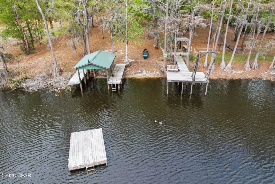 From the moment you enter this property your breath will be taken away with the unbelievable views and well thought out landscaping!
This rare lakefront cottage is nestled on its own peninsula with approximately 1200 feet of water front on Lake Bowen. Lake Bowen is a natural spring fed lake with access to three other surrounding lakes.
A fisherman and duck hunters dream!
With this much water front, this property features not one but five docks! Including a floating dock and a boat house that can hold up to a 20 ft boat! Oh and let's not forget the custom Steel bridge that connects both sides of the property! Spend your days jet skiing, fishing, or just enjoying Floridas beautiful nature.
There is also a beautiful Pergola with a gas burning fire pit making that a total of three fire pits on the property! Stepping up to the backside of the home you're warmly welcomed with the very large wraparound deck! You can spend your mornings drinking coffee enjoying the beautiful view! This two-story cottage was built with concrete filled blocks for durability. Not only is it striking it is also enduring! This home features 1600 ft.² three bedroom two full baths. 
The great room feels great, with 16 foot ceilings and plenty of windows to admire the scenery. 
You literally will feel like you are on vacation! Stepping back outside you will be pleased knowing you have plenty of room to store your vehicles, boats, tractors, or even jet skis with 1,162 sq feet of storage!
There is a deep well for irrigation, so keeping your lawn beautiful all year is easy!
I could go on but you would have to see this property yourself! Definitely one of a kind!
Schedule your showing today! Don't let this opportunity to own your piece of paradise slip away! All information deemed accurate but should be verified by buyer.