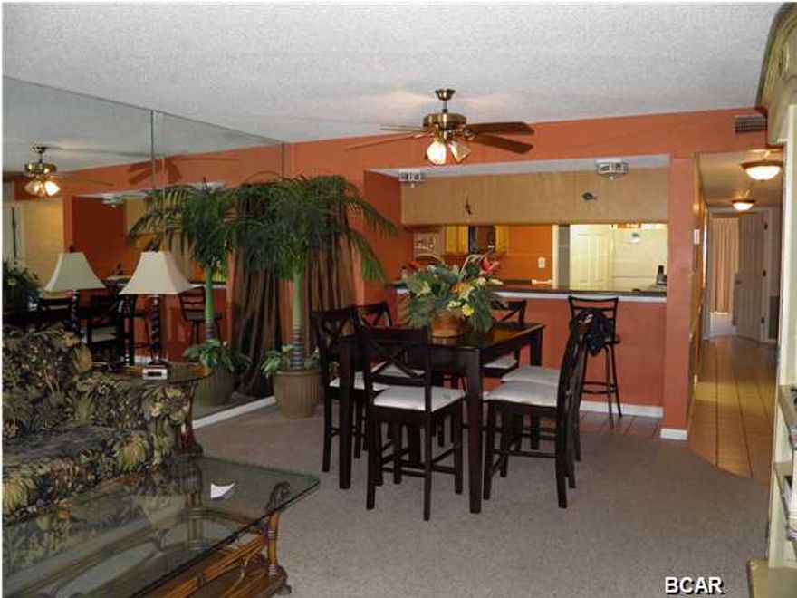 SELLER SAYS BRING ALL OFFERS!READY TO SELL!!! Brand new AC! This Unit has many upgrades! Kitchen all new cabinets and new counter tops, new lighting fixtures and crown molding, Beautiful Rustic wood tile floors in bedrooms and living areas. The Entire Unit has been Painted. Live in this home or put on a rental program. It is a tropical setting and from your Living Room/ Dining room/Kitchen and Master Bedroom you have a beautiful view of a large pond with a fountain. The Condo is lovely with a beach feel. Both bedrooms are extra large with king size bed in the Master and two Queens in the spare. The master Bed room has a large walk in closet, and a nice large garden tub. It has been well taken care. a wonderful Gulf Side Restaurant, Tram Service, Golf Course (free for owners), Tennis Court, Physical Fitness Center and a Corner Market. A very short walk to the beach, shopping and restaurants.