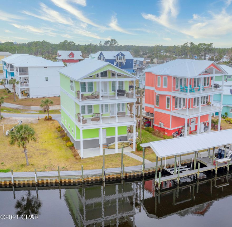 Gorgeous WATERFRONT home offering the ultimate level of luxury and perfection. This 3-story masterpiece located in a gated community has been meticulously designed with exquisite architecture providing both comfort and elegance with spectacular top of the line finishes throughout. Take the three stop Mowrey elevator to the top floor of this dream residence and you will find an open living/dining room loaded with natural light and views of the bay, vaulted wood ceilings, a chef's dream kitchen boasting custom cabinetry, stainless steel state-of-the-art appliances, quartz countertops, walk-in pantry and an island with breakfast bar. To complete the top floor is a lavish master bedroom with en suite bath featuring double sinks and custom tiled shower. Your guests will feel a sense of privacy on the second floor with their very own sitting room with kitchenette, 3 bedrooms, full bath, laundry room and private balcony! Unload your fresh catch from the 32 ft boat slip equipped with a 12,000lb lift, shower off in the full bath located on the ground floor then enjoy cooking on your back patio overlooking the canal. Home is up to date with the newest technology including LED lighting, energy efficient HVAC, tankless hot water heater, water filtration system, whole house generator and video surveillance. Property is located in Harbour Cove Village minutes from shopping, restaurants and the world's most beautiful beaches.