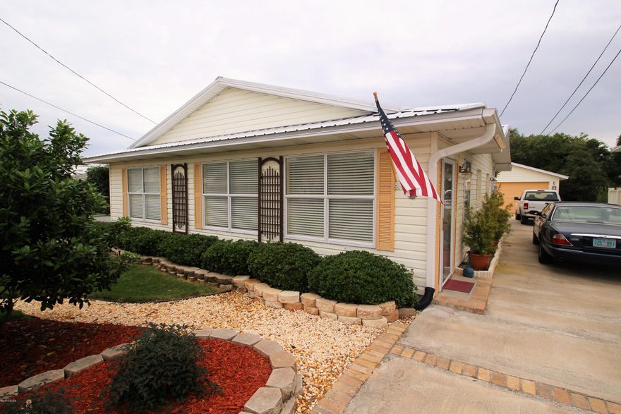 A beautiful cottage styled home that's located just a few blocks from the beach on the desirable Riviera Beach community on the west end of PCB. It has an oversized 21'x12' master bedroom, open kitchen with stainless steel appliances and eat-in bar area. The kitchen, dining room and living area are all connected to create an open living concept with real hardwood flooring. A beautiful rear patio with pavers leads out to a private rear lawn adjacent to the detached garage with work space. Many updates have recently been made to this lovely home. **all important listing info must be verified.