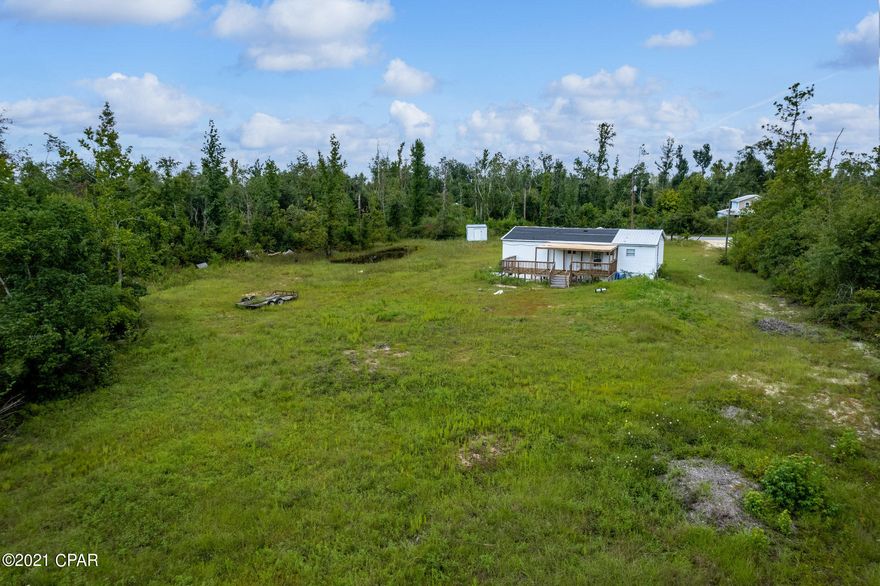 UNDER CONTRACT, TAKING BACK UP OFFERS!  3 acres of peaceful country living and only 10 minutes from town. This lot is cleared with electric, well and septic already in place.  The property has two ponds, is on a dead end and has mature trees bordering 3 sides, giving you privacy from neighbors. Its a great location to watch the deer graze and escape the hustle and bustle of the city. Mobile home on the property is damaged and has no value – salvage what you want and demo the rest for a clean slate to build your dream home or place a new mobile home!