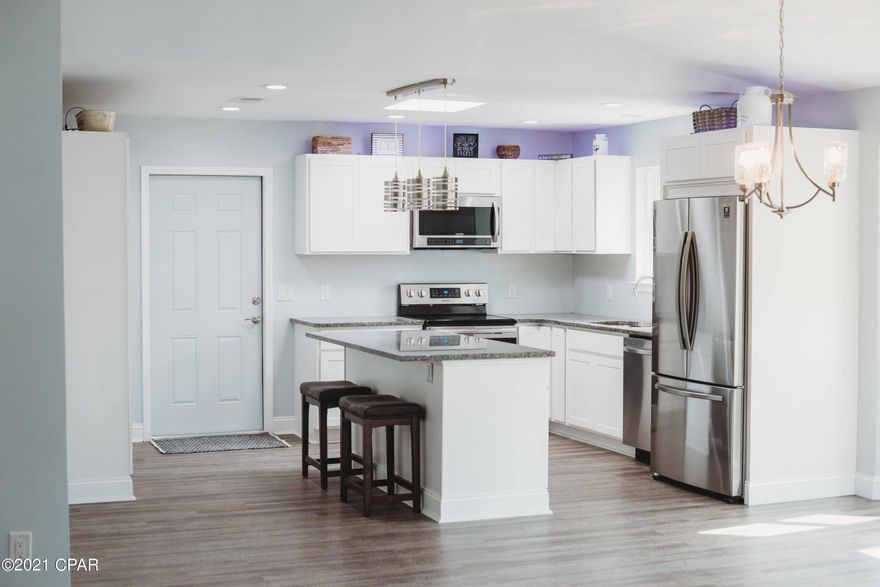 Under Contract. Seller accepting backup offers. This home is completely updated w/ modern finishes like the marble faced fireplace that extends to the vaulted ceiling, open floorplan with a dream kitchen! You'll find new SS appliances, granite countertops, island seating, upgraded cabinetry with standalone pantry and pullout drawers. Not to mention, the built-in wine cooler! The living room leads out through the new sliders to a spacious back deck for family BBQs! The master BR is huge w/ his&her closets, beautiful en suite w/ quartz vanity and tile shower, 2 more spacious bedrooms & hall bath. The home boasts a new roof, new hot water heater, new HVAC, new windows & doors, new vinyl B&B siding, new LVP flooring, new modern fixtures and cabinets. Conv to TAFB! Storage building outside does convey with no value consideration. Any furnishings and/or decor in pictures and home are for staging only; home conveyed unfurnished.