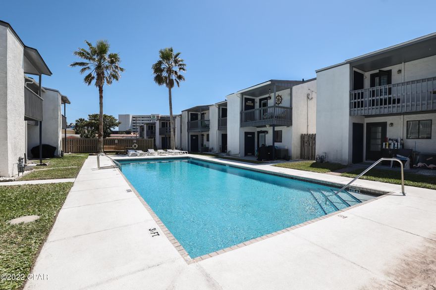 Incredible investment opportunity in Panama City Beach!!! This Beach Townhouse is just 1 BLOCK from the white sandy beach. --SHORT TERM VACATION RENTALS ALLOWED--- This beautifully remodeled 2BR / 2BA property is in a small private townhouse community with a private pool and private green space common area. The downstairs bathroom was remodeled to add a full stand up shower allowing guests to have two full baths. Please find rental history in documents tab. (All sizes are approximate and should be verified if deemed important to the buyer.)