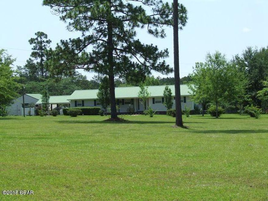 Quiet Country Living , yet close to town!  This 3 Bedroom 2 Bath well kept home is located on a beautiful 13.4 acre parcel with room for the kids, horses, cows, goats, chicken, and ducks.  Fenced and cross-fenced, just right for the hobby farmer.  Stocked fish pond with bass, bream, and catfish.  Entering the front door you will see the spacious dining room, then the large eat-in kitchen overlooking the sunken family room with it's own woodburning fireplace with insert for efficiency. Off the family room is a spacious sunroom for relaxing. As you head toward the 2 car carport, enter the perfect 17x20 man-cave, rec room, or den - whatever you want it to be! Out front is a spacious, well landscaped front yard.  In the back is a fenced ORGANIC garden! Fruit trees & more! Call today to see it!