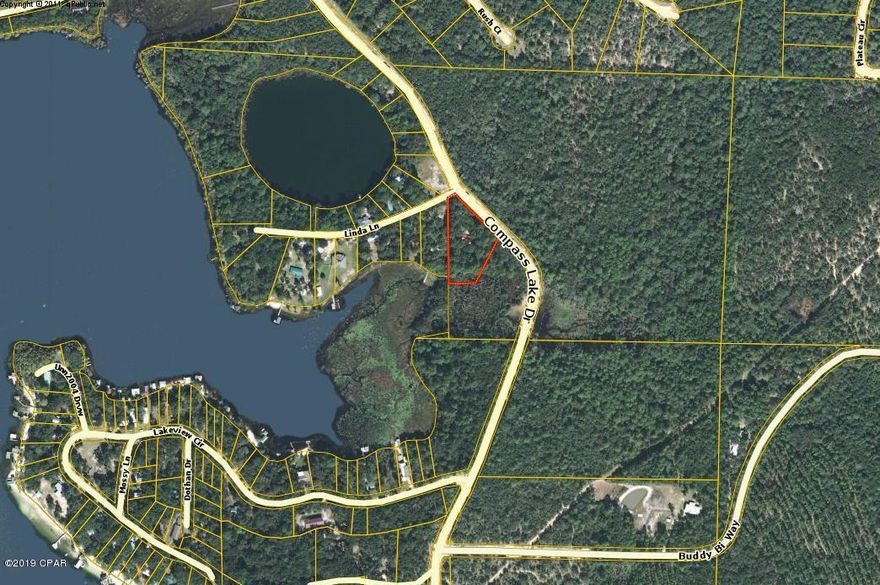 CURRENTLY UNDER CONTRACT SELLER WILL STILL SHOW AND TAKE BACKUP OFFERS.  Want a Lake House??  Here's A Great Opportunity to have one at Compass Lake in the Hills! This home/property has damage from Hurricane Michael but there is TONS of potential to make this a wonderful property for your Country Lake House enjoyment.  Home features 3 bedrooms, 2 baths, split floor plan, step down living area with stone fireplace and sliding glass doors that look out over the backyard towards the lake.  The master bedroom has sliding glass doors as well that would lend to a wonderful view of the lake as well.  Home is situated on a paved road for easy access and there is a chain link fence on at least 3 sides of the property. Being sold as is where is. Thank you for considering this home All information and measurements 
 are approximate and should be verified if important by buyer and/or buyers agent
