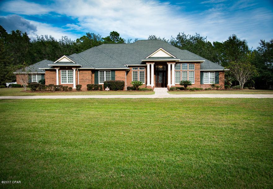 All-brick, waterfront home w/private boat dock, boasting nearly 3 acres of land, 3,765 SqF of living space, with an additional 1,000 SqF detached garage and spacious screened in patio. Single story, split floor plan, 3 bedrooms each w/ private bath/walk-in closet. Office could be 4th bedroom. Ultimate tranquility awaits; home is located in a private walled and gated compound with only 3 other homes. TWO workshops, one in garage, and one in separate metal building with 12X12 entry door, a lofted area, and a monorail for lifting heavy equipment. Gardener's paradise, property has a variety of fruit and palm trees. Solid hard open cell foam Insulation on all exterior surfaces, including in ceiling rafters, in garage and in 2x6 wall studs. Attic storage area is same temperature as living area.