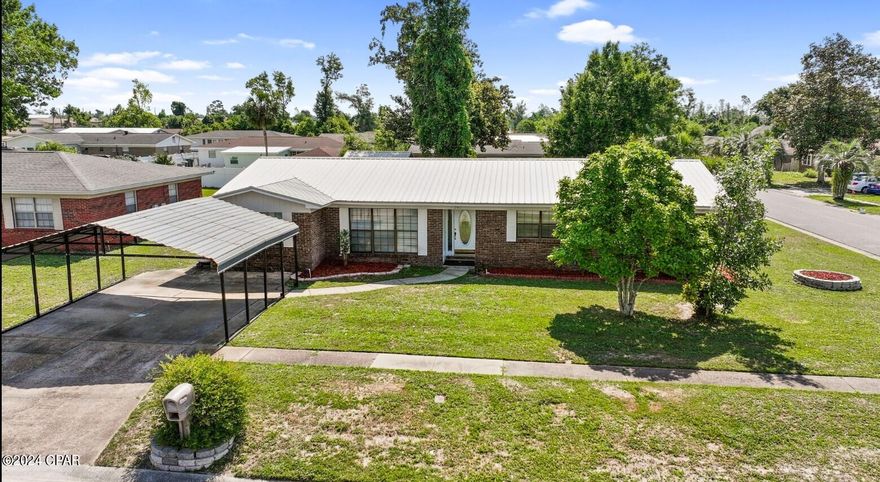 UNDER CONTRACT with up to 72 hours KICK OUt CLAUSE. This home checks all the boxes. Take a look at this newly renovated four-bedroom, two-bath home, with a large fenced-in backyard, a large inground pool, a yard building, and a private paved parking area behind your backyard private gate, perfect for keeping your recreational toys parked off the street. Walk through your front door, look to the left, and find French doors leading to a formal living room or keep walking straight to the second living area, which is an open-concept style space with a second family room and kitchen combo with views of the pool, perfect for enjoying your family and entertaining your guests. The kitchen offers a large island with a breakfast bar, granite countertops, and plenty of counter space and storage. From the kitchen, you will find a separate dining room, a bedroom, and a large laundry room with extra storage and an exterior access door. On the opposite side of the home are three large bedrooms and two bathrooms. The Primary Bedroom has two sizeable closets and an ensuite with a walk-in tub with jets, so it can be spa day every day. The whole interior of the home has just been freshly painted, has upgraded lighting, and all the floors are luxury vinyl plank. Every detail has been attended to. The home is located on a well-manicured corner lot, with no HOA fees or Flood Insurance required. The home also has a generator as an added bonus. Enjoy being conveniently located close to many employment opportunities, including Tyndall Air Force Base, many shops, gyms, cafes, and restaurants, multiple parks including recreational parks, parks with extensive playground equipment, dog parks, and parks with water access for boating and fishing. The location could not be more ideal for enjoying your everyday life, and of course, Panama City Beach is just a short drive to the other side of town. Call your favorite Realtor today; this one will not last long. It is reasonably priced and is located in a good neighborhood. The new owners will enjoy a lot of value from this home.