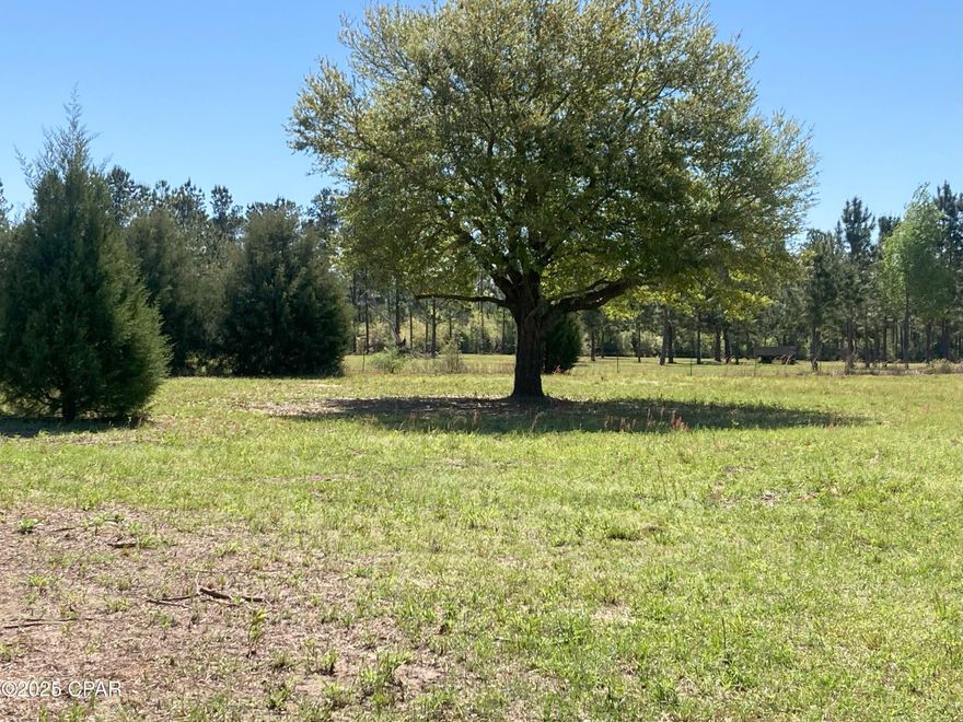 Premium (Choice) 5 ac. tract, level, hi and dry just South of Marianna Fl with highway frontage, fenced , gate at the entrance. Beautiful Oaks scattered across the property.  EXCELLENT HOME SITE.  About 5 miles to I-10 exchange and 5.5 miles to Walmart Super Center, Lowe's, Restaurants and Hotels, Fuel Centers.  Easy access to Marianna , Tallahassee, Panama City, Panama City Beach.  Quiet area ! These tracts in this condition and location are difficult to find. Enjoy gardening or bring your horses, pets or chickens. Easy deed restrictions apply. Call today!