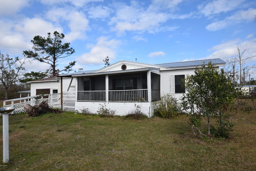 CURRENTLY UNDER CONTRACT, SELLER ACCEPTING BACKUP OFFERS. Well maintained double wide mobile home on almost 1 acre of land.  New metal roof 2 years ago.  No storm damage to the home.  There is an attached enclosed carport and a a wired workshop.  Peaceful country living only 20 minutes from Marianna, 45 minutes to Panama City Beach, and only 2 hours from Tallahassee. Priced to sell!