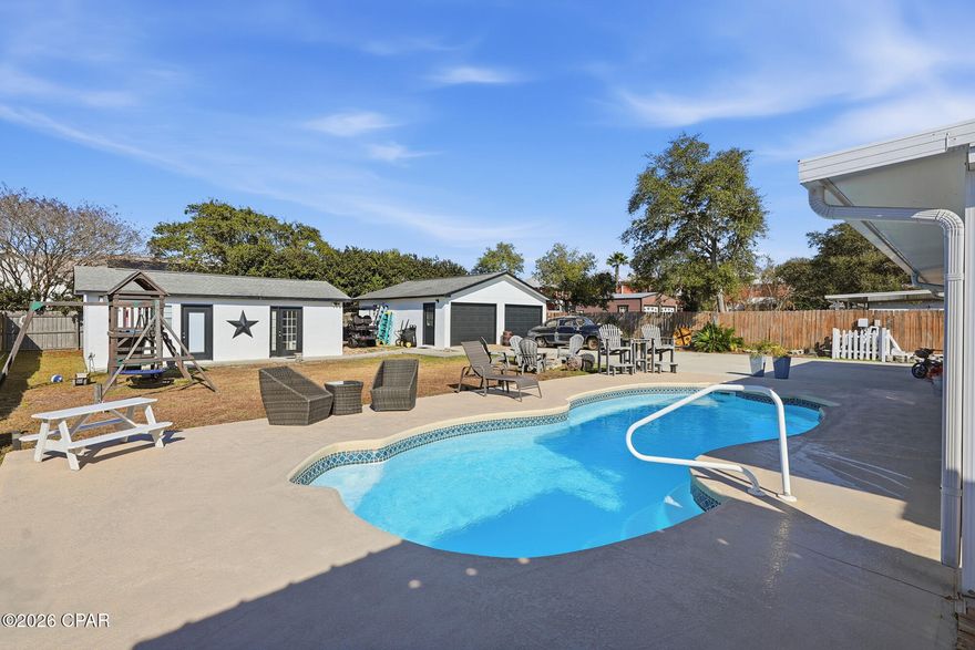 Located in the highly desirable west end of Panama City Beach and 5 minutes to 30A in the Gulf Vista Subdivision, 206 Nancy Avenue offers a rare opportunity to own a spacious coastal home on an oversized .33-acre lot just minutes from the beach with a guest house and a large separate building/Garage Perfect for full-time living or a second home or STR , this property delivers the ideal combination of privacy, outdoor living, and unbeatable storage for all your beach lifestyle needs.

This 3-bedroom, 2-bathroom home features approximately 1,658 square feet of living space with an open living and dining layout, tile flooring throughout, and a functional floor plan designed for low-maintenance coastal living. Step outside to a large covered H/C back porch overlooking your private backyard oasis, complete with an in-ground pool, covered patio space, tropical landscaping, a fenced yard, outdoor shower, and firepit, perfect for relaxing or entertaining year-round.

One of the standout features of this property is the exceptional parking and storage setup, featuring an attached one-car garage plus a detached two-car garage, providing ample space for vehicles, boats, golf carts, or workshop use. An additional heated and cooled mother in law cottage adds even more flexibility, ideal for guests, hobbies, a home office, or extra storage.

Situated in the quiet, golf cart-friendly Gulf Vista subdivision where short-term rentals are permitted, this home offers a peaceful residential setting while still being close to shopping, dining, and the beach. If you've been searching for a west end property with space, a pool, multiple garages, and true coastal lifestyle potential, this is one you don't want to miss.