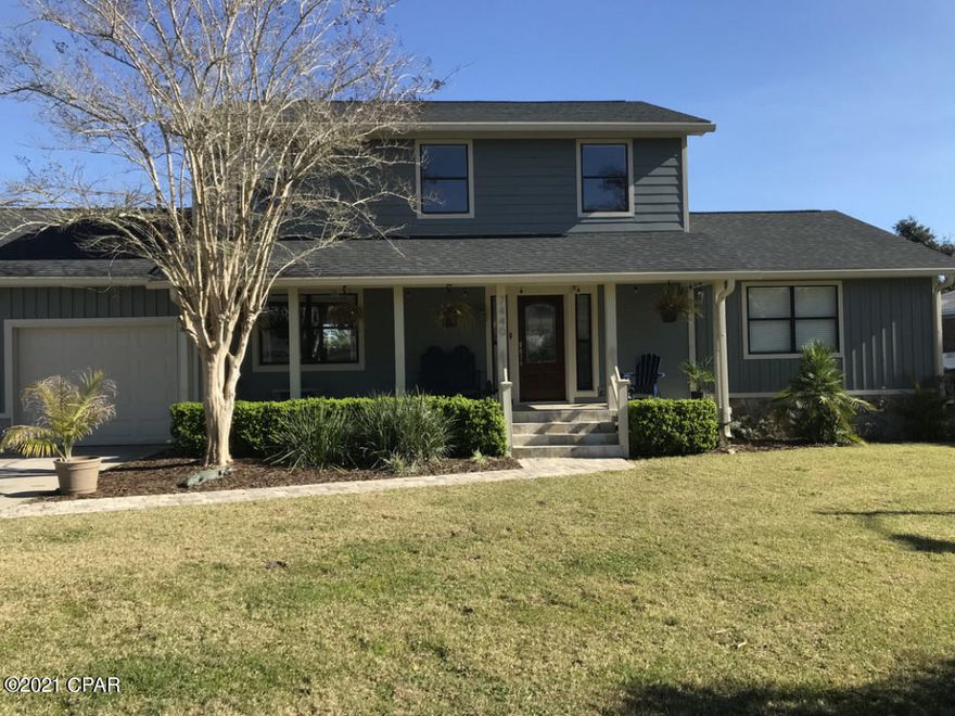 Beautifully remodeled waterfront home, boathouse and large dock with Gulf access about 6 miles from Tyndall AFB. This home's unique features include shallow well sprinkler and HVAC systems, granite counters, oversized 2 car garage with epoxy floor, and a hardwired Alexa enabled central camera and entertainment system. Engineered hardwood flooring throughout and a new custom two level deck. You will love observing the wildlife that live here. Daily visits from the hummingbirds, cardinals, bluebirds, purple finches, herons, ospreys, pelicans and cormorants. Frequent visitors include dolphins, bald eagles, turtles and otters with seasonal visits from manatees. Abundant fish, crab and other sea life call this beautiful living bayou home. The magnificent hand crafted 8ft tall Pelican sitting on a piling, the centerpiece of the large bird feeder garden, was carved out of the remains of a large pine tree felled by Michael. The open concept den/kitchen includes SS appliances, coffee bar,  oversized apron sink, and granite counters with pop-up outlets. The custom etched glass door leads into the huge laundry room. The sliding glass door leads to the large balcony where you can grill your food while enjoying the beautiful view or just relax with your morning coffee or evening beverage. Most of the indoor and outdoor furnishings are negotiable as well as all of the yard maintenance equipment.