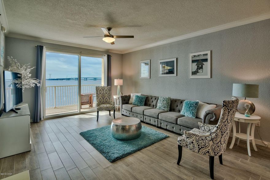 This tastefully updated, two-bedroom, two-bathroom condo in the gated community of Hibiscus by the Bay has amazing views of St. Andrews Bay. This condo will be sold furnished with some owner's exclusions. Tile wood floors run throughout this unit. The open living, dining and kitchen are ideal for entertaining or family get togethers and offer bay views. The kitchen was updated with granite countertops, custom cabinets and new appliances. Added shelving and storage were installed in the kitchen area as well. The living room and master bedroom have access to the large balcony offering gorgeous bay views. The master bathroom has dual vanities, a large walk-in closet and a separate glass, tiled shower and jetted tub. The condo has a central vacuum system making cleaning a breeze. The fireplace in the living room is ideal for cool Florida nights. The condo has a full-size washer and dryer as well. There is a guest room on the front of the condo. And another full bathroom completes this amazing property. Hibiscus by the Bay has it all: A 500-foot fishing/walking pier over St. Andrews Bay, garages for lease, a marina with boat slips available for lease, a tennis court, an exercise room, a hot tub and pool, a library and a community room for get togethers. The pool deck has plenty of chairs and space to enjoy the Florida sun and several grilling areas.