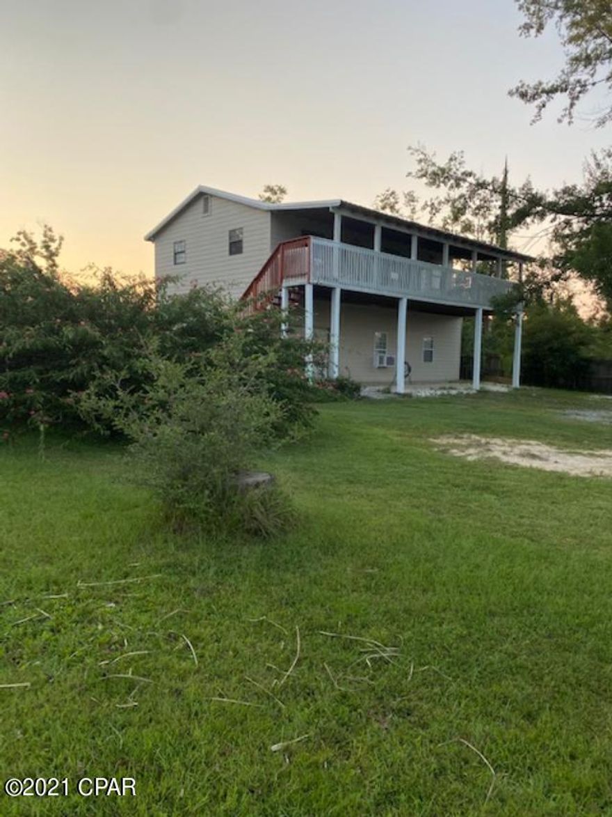This three bedroom, two story, 2 1/2 bath home, is move in ready.  It is located in a desirable area of Panama City, near the intersection of hwy 390 and Transmitter rd.  The living area has new laminate flooring and new carpet in the bedrooms. It has a new metal roof.  The front deck is 42 x 10 and has a great view of the pond in the front yard. The first floor consists of a 23 x 29 open area, with 2 bonus rooms on the end and a half bath.  The home is built on the back of the 300' deep lot and is almost hidden from the road. The homes in this area are on larger lots, which ensures more privacy and less traffic. New a/c in​​‌​​​​‌​‌​​​​‌​​‌​​​​‌‌ 2018.