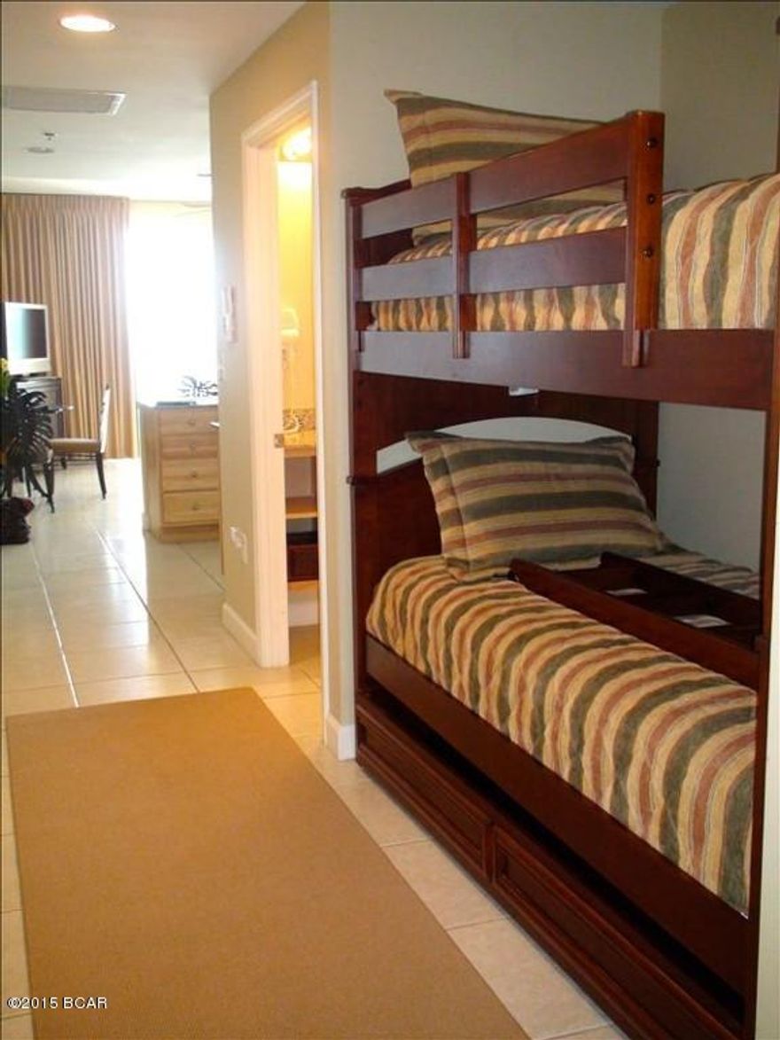 Luxe beachside living at Splash. Enjoy this beautiful condominium with upgrades including tile floors throughout, granite counters and beautiful furnishings. A spacious Master Suite plus hall bunks and sleeper sofa means this condo easily sleeps 6 plus 2 large bathrooms complete with wood cabinetry and granite counters. Perfect elevation within the stack! Property has been meticulously maintained. HVAC replaced 6/15, hot water heater, kitchen stove, kitchen faucet, & refrigerator replaced during the last two years. Splash offers amazing resort style amenities including: waterpark, including a kids' pool park with waterslides, interactive water toys, a lazy river ride, ''dive-in'' movie theater, arcade, state of the art fitness center, a pool and Jacuzzi just for the adults and a poolside bar and grill. All this plus covered garage parking, a beach apparel/surf shop and on-site rental management & check-in desk. Just minutes to all the best restaurants, shops and entertainment and of course exciting Pier Park! 2014 Gross Rental income: $34,707.00, 2015 Gross Rental income as of 9/13/15: $36,685.00 *Kaba lock does not convey.