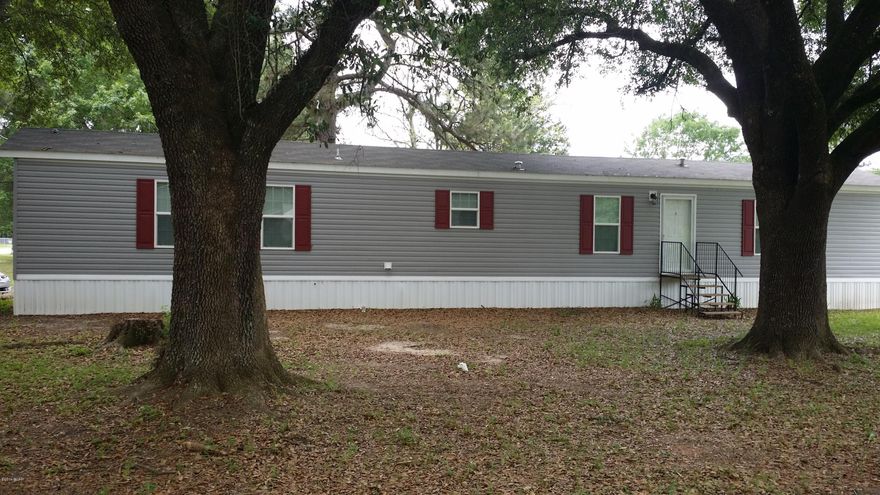New 2015 Mobile Home situated on nice corner lot with majestic oak trees that provide shade during the summer months. Great starter home for young couple. Very nice quiet neighborhood. Comes with a incomplete pole barn that needs a roof installed to complete