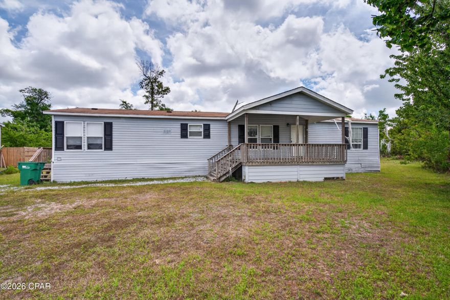 Perfect opportunity for DIYers, investors, or first-time homebuyers looking to build instant equity! This spacious 3-bedroom, 2-bath mobile home is tucked away at the end of the street and backs up to a wooded area, offering extra privacy and a peaceful setting. With a little TLC and new flooring throughout, this home has incredible potential to shine.

Enjoy outdoor living with two oversized decks, including a covered 10x16 front deck that's perfect for relaxing with your morning coffee or entertaining guests. The chain-link fenced backyard is ideal for pets, kids, or extra outdoor enjoyment. Inside, the spacious living room features sliding glass doors leading to the back deck, creating a bright and open feel.

The huge kitchen offers an abundance of cabinet and counter space, a breakfast bar, and a roomy dining area perfect for family meals or gatherings. All appliances except the dishwasher are included, making move-in even easier. The split-bedroom floor plan provides added privacy, with generously sized bedrooms throughout. The master suite features two closets, including a walk-in closet, plus a garden tub and convenient access to the laundry room.

Conveniently located just minutes from Tyndall Air Force Base, Eastern Shipbuilding Group, and downtown Panama City, this property offers easy access to work, shopping, dining, and entertainment. Whether you're searching for an affordable primary residence, rental investment, or your next renovation project, this home is packed with potential and value.