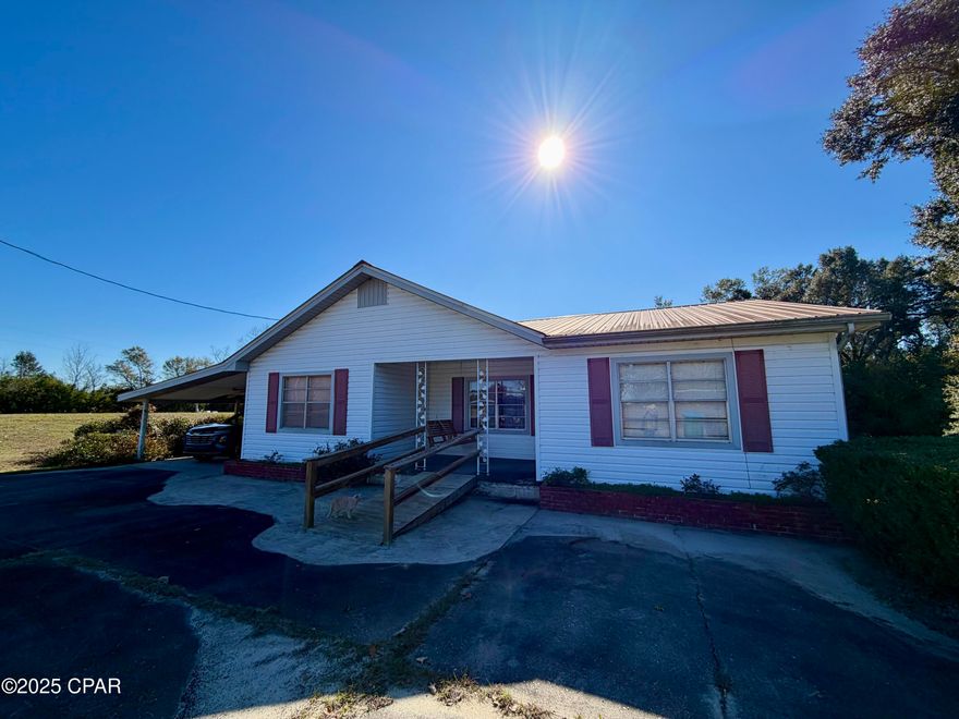 This home has been well loved by its current owner and is ready for you to fall in love with it, too! Offering 3 bedrooms, 2 baths, plus a versatile space that could be used as a home office, this property provides room to live, work, and grow.

The spacious living room features a built-in cabinet and counter with space for a fryer—perfect for hosting fish fries and gatherings. The dining room opens seamlessly to the kitchen, which boasts solid wood cabinets.

If you enjoy canning or gardening, you'll love the oversized utility room, complete with a sink, large work table, shelving, and space for a stove—ideal for processing homegrown vegetables.

The home features central heat and air, along with window units for added convenience. Original gas heaters add nostalgic charm but are not currently connected.

Situated on a corner lot with ample room for a garden, the property includes a tall carport with sides and a concrete floor for storage, plus a two-car carport attached to the home. Relax on the front porch swing and enjoy the peace and tranquility of country living.

With endless potential, this home is ready for your personal touch!