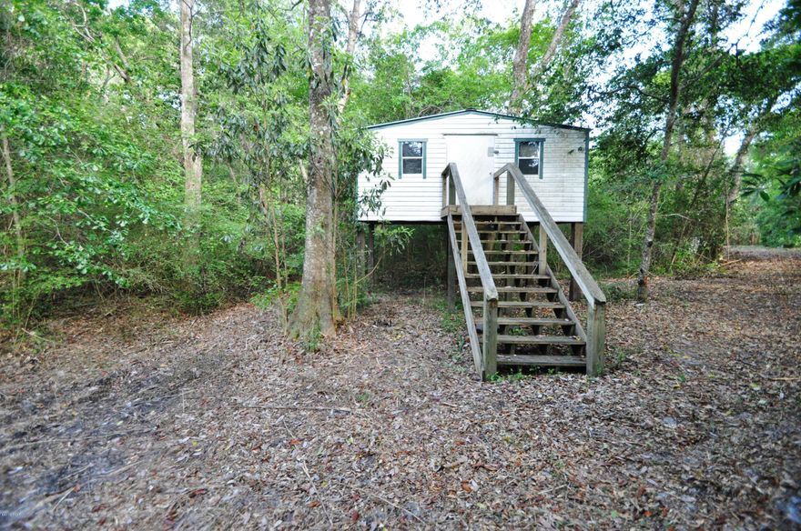 2 acres in the Middle of Callaway. 1/2 mile to shopping, restaurants and more. This beautiful property has a creek running through it. Part of it has recently been cleared for a homestead along the creek, with the well already installed. There is a nice Arbor to sit under in the evening and listen to the creek flow by. There is already a 10x10 storage building/workshop on the property. Build a bridge across the creek and put your home way back in the woods, or build several homes on the property for your family. If you are a developer you could build a 4 - 6 home private community. There are all sorts of things that could be done here, right in the heart of the city! 10 mins or less to Tyndall AFB, 2 mins to the Walmart. There is a 25' easement to drive back to the property off N Gay.