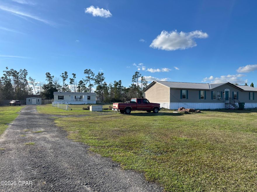 CURRENTLY UNDER CONTRACT, SELLER WILL CONSIDER BACKUP OFFERS >>> WOW...  USDA Eligible >>> 2.5 acres with 2 double-wide's, 2 septics, 2 power poles w/ underground elec, 1 well & an above-ground pool, plus 2 sheds.  Country living in Southport, and just a stone's throw to Lynn Haven with all the shops and necessities.  The home toward the back is 3 bdrm, 2 full baths with sunroom & above ground pool.  Fenced in for your kids & pets.   Nice, open kitchen, dining, & living area.  Island & pantry in kitchen, SS appliances (LG), double oven.  Split floorplan.  Large master w/ ensuite.  Double vanity, walk-in shower.  Other side of home has 2 guest rooms and a full bath.  Laundry room leads out to spacious sunroom.  Out the back door to a nice deck and pool access.  6ft privacy fence & a shed in the backyard and one at the top of the driveway.  Additional outside storage off front porch.  Move-in ready.  Second home in front, closer to street, larger at 1872sf.  Needs major work or haul-away.  New roof in 2024, but needs AC, flooring, cabinets.  3-5 bedrm, 2 full baths.  Fix it up & save it for a friend / family, or rent it out for some extra income!! Driveway easement along edge of property.  All measurements approximate.  Re-measure if important.