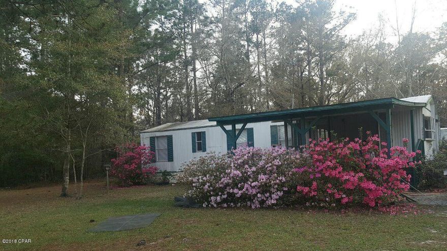 Income producing-Nice country setting with 2 single wide mobile homes on 5 acres. The 2/1 home has eat in kitchen with breakfast bar, living room, laundry hookups, screened front porch. The 3/1.5 home as eat in kitchen, living room, laundry hookups, covered front porch. Well and septic on property. The property is cleared around the rentals and the back is wooded.  Great investment opportunity.
