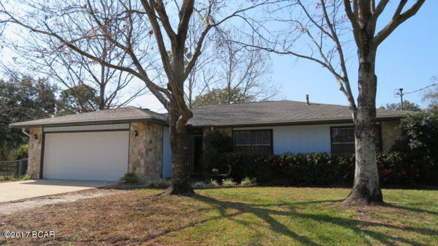 Tyndall area… Very well kept 3 bedroom, 2 baths home on a large corner lot. This home features a brand new roof, fresh exterior paint and wood laminate flooring in all living areas, a spacious living room with stone fireplace & a formal dining room. The kitchen has been updated with new counter tops and tile back splash and all appliances are included. The cozy breakfast area offers a nice view of the lovely back yard. The master bedroom features a multi-purpose nook/office space. An updated master bath features a shower with seats and grab bars. Enjoy relaxing in the HotTub on the 11x35 screened porch  and a raised deck is an inviting area for outdoor gatherings. A 12x30 boat/car port is attached to a 12x16 work shop & you will love the mini citrus orchard & rose garden. Come see today!