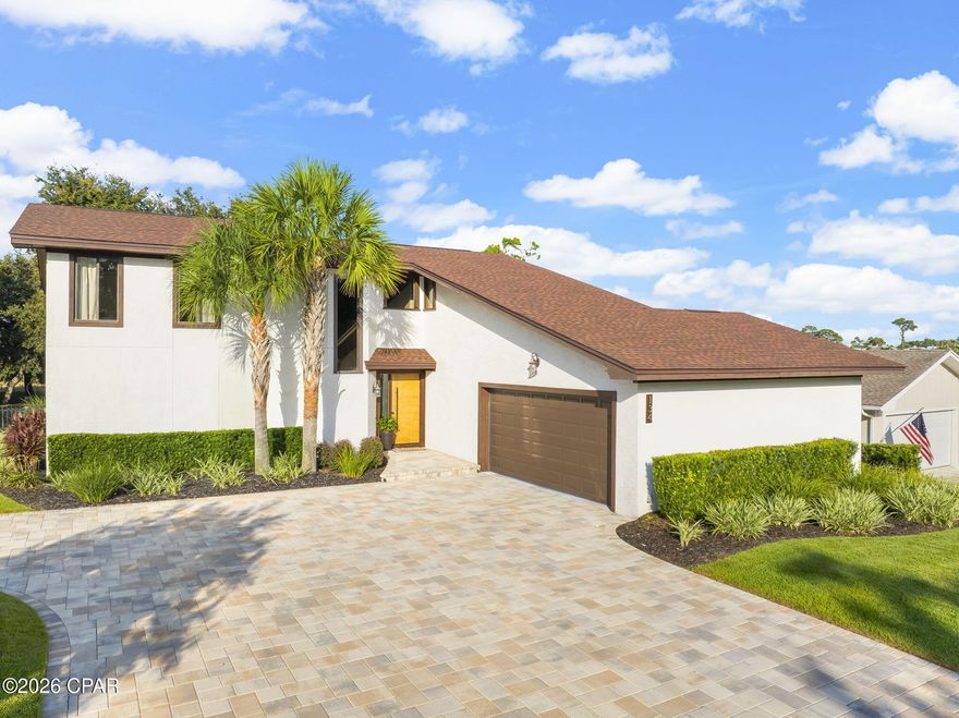 Located in the highly sought-after gated community of Bay Point on the east end of PCB, this beautifully maintained and updated 4-bedroom, 2.5-bathroom home is full of character and charm. Beautifully maintained and thoughtfully updated, it is truly a special property.

As you arrive, you're welcomed by an oversized paver driveway, meticulously landscaped grounds, and stunning accent landscape lighting that showcases the property's curb appeal.

Inside, the vaulted-ceiling living room creates an airy, inviting atmosphere, anchored by a wood-burning fireplace. The open flow leads into the updated kitchen featuring stainless steel appliances, a glass cooktop, granite countertops, recessed lighting, and a stylish tile backsplash, along with a cozy eat-in dining space. Adjacent, the formal dining area overlooks the living room and kitchen and opens to the rear covered deck, perfect for entertaining or relaxing while enjoying the fully sodded backyard framed by majestic oak trees.

The oversized primary suite offers a private retreat with sliding doors to its own deck. The en suite bathroom includes a double vanity, tiled floors, and a large tiled shower with a bench seat. A flexible bonus room behind the living area can serve as an office, den, or study.

Upstairs, a landing overlooks the living space, leading to three bedrooms and a full bathroom with a double vanity and tiled tub/shower combo. One rear bedroom includes a sliding glass door to a covered balcony overlooking the backyard.

Additional highlights include: Two-car garage with epoxy floors. New roof (2019). Updated AC (2018-2023) and water heater (2018). 

Nestled securely within Bay Point, residents enjoy premium amenities including 24-hour roving security, the exclusive Nicklaus Golf Course (the only one in Northwest Florida), and Point South Marina, a full-service facility with fuel dock and slips accommodating yachts up to 120 feet.