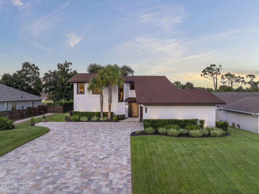 Located in the highly sought-after gated community of Bay Point on the east end of PCB, this beautifully maintained and updated 4-bedroom, 2.5-bathroom home is full of character and charm. Beautifully maintained and thoughtfully updated, it is truly a special property.

As you arrive, you're welcomed by an oversized paver driveway, meticulously landscaped grounds, and stunning accent landscape lighting that showcases the property's curb appeal.

Inside, the vaulted-ceiling living room creates an airy, inviting atmosphere, anchored by a wood-burning fireplace. The open flow leads into the updated kitchen featuring stainless steel appliances, a glass cooktop, granite countertops, recessed lighting, and a stylish tile backsplash, along with a cozy eat-in dining space. Adjacent, the formal dining area overlooks the living room and kitchen and opens to the rear covered deck, perfect for entertaining or relaxing while enjoying the fully sodded backyard framed by majestic oak trees.

The oversized primary suite offers a private retreat with sliding doors to its own deck. The en suite bathroom includes a double vanity, tiled floors, and a large tiled shower with a bench seat. A flexible bonus room behind the living area can serve as an office, den, or study.

Upstairs, a landing overlooks the living space, leading to three bedrooms and a full bathroom with a double vanity and tiled tub/shower combo. One rear bedroom includes a sliding glass door to a covered balcony overlooking the backyard.

Additional highlights include: Two-car garage with epoxy floors. New roof (2019). Updated AC (2018-2023) and water heater (2018). 

Nestled securely within Bay Point, residents enjoy premium amenities including 24-hour roving security, the exclusive Nicklaus Golf Course (the only one in Northwest Florida), and Point South Marina, a full-service facility with fuel dock and slips accommodating yachts up to 120 feet.