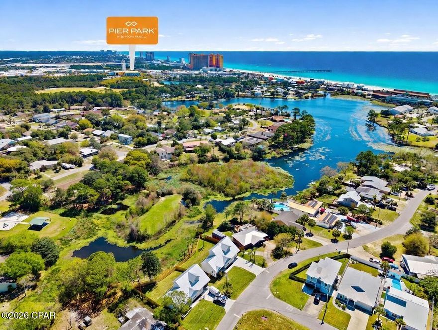 Waterfront Luxury New Construction on Lullwater Lake! Introducing an exceptional waterfront residence on Lullwater Lake, where refined design meets effortless coastal elegance. This newly built two-story home offers 1,817 sq ft of curated living space, featuring 3 generously sized bedrooms, 2.5 designer baths, and a main-level primary suite for elevated comfort and privacy. Built with quality and efficiency in mind, highlights include hurricane-impact windows and exterior doors, a Taexx in-wall pest control system, reclaimed-water irrigation, gutters, wrap-around fencing, spray-foam roof deck insulation, and dual mini-split A/C units for individualized climate control upstairs and down. An oversized 1-car garage adds extra storage and convenience. Enjoy no HOA and no flood zone, plus a prime location just a short stroll to the beach, minutes from Pier Park for dining, shopping, and entertainment, and close to the recreation and sports facilities at Frank Brown Park Includes a 1-year builder warranty and 1-year transferable termite bond. Ideal as a primary residence, second home, or long-term investment in a peaceful community (short-term rentals not permitted). Schedule your private tour today and discover waterfront living at its finest.