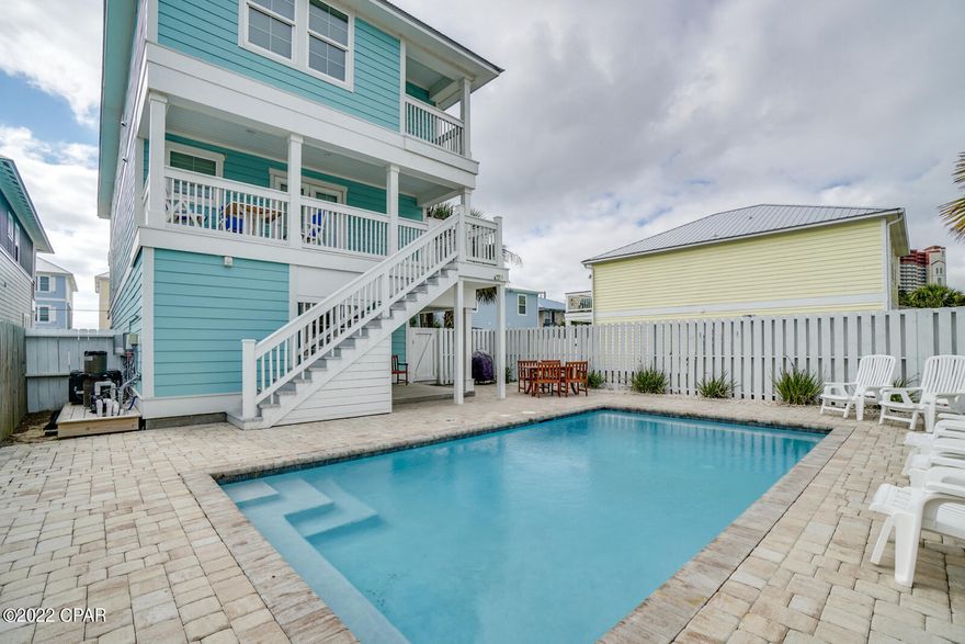 CURRENTLY UNDER CONTRACT. SELLER ACCEPTING BACK UP OFFERS.  ''JUST BEACHY'' is the perfect answer for Beach Lovers! Location...location....This one is directly across the street from the beach.... 20 STEPS To Sugar White Sand and Emerald Waters!  This 7 bedroom with 6 full baths & 2 half baths, Large open living/dining/ kitchen area, game area, covered patio and PRIVATE HEATED POOL, offers generous space for family and friends to gather, relax and make great memories! Plenty of parking with both covered and open driveway parking.  Fully furnished and ready to go....A great investment whether a primary residence, second home or rental.  Come visit today.......You will not want to leave!!