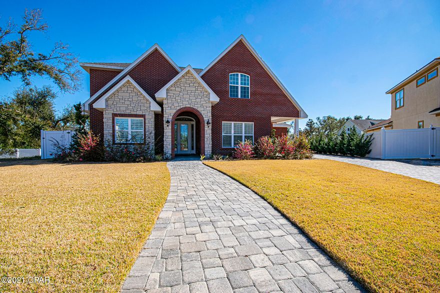 Located in the exclusive Cove Pointe neighborhood, this custom-built brick and stone home is a true show stopper! Enter through the beautiful beveled glass front door into the foyer that leads to an entertaining family's dream with an open concept design that flows flawlessly. Your eyes are immediately drawn to the floor to ceiling windows and French doors that lead to the expansive screened in Florida room and directly out to the unbelievable outdoor living space which features a heated Pebbletech saltwater pool and hot tub with lush landscaping along with a 3-burner Weber gas grill for Bar-B-Q entertaining. Beautiful Brazilian Cherry manufactured hardwood and porcelain tile run throughout both floors of this home. The spacious private master suite offers French doors to access the pool and designer his and hers closets. Relax in the en-suite bathroom with double Corian vanities, a glass walk-in shower and a free-standing soaking tub. Crown molding and arched doorways along with coffered ceilings and glass shelved built-ins adorn the living room. The quartz countered wet bar area with GE wine refrigerator and glass front cabinets will stun your guests. The living room flows freely into the Chef's kitchen that boasts all stainless-steel appliances, including a GE Profile gas stove plus an additional set of GE double ovens, a LG Inverter Linear refrigerator and BOSCH dishwasher. The abundant custom cabinetry, glass subway tile back splash, quartz counter tops, amazing pendant lighting and full size walk-in pantry must be mentioned; although, the true focal point is the enormous quartz topped island which is the perfect place to gather with friends and family. Whether you are entertaining a crowd or hosting a dinner in the formal dining room, this home is where memories are made. Off the kitchen, you will find another large bedroom and a beautiful bathroom with walk-in shower. And laundry isn't a chore in the large utility room with a deep sink, Corian counter tops and plenty of cabinets along with a second refrigerator. Make your way upstairs, to find two more gracious sized bedrooms (one currently being used as a den/office) and a shared bathroom. The oversized double car garage has plenty of space to house your golf cart. The home is Wi-Fi-enabled with access to the pool system as well as the security cameras and has a surround sound system that flows through the main living area. Call today to visit this beautiful one of a kind home.

(All sizes approximate and taken from public records, Buyer to verify any and all details Buyer deems important.)