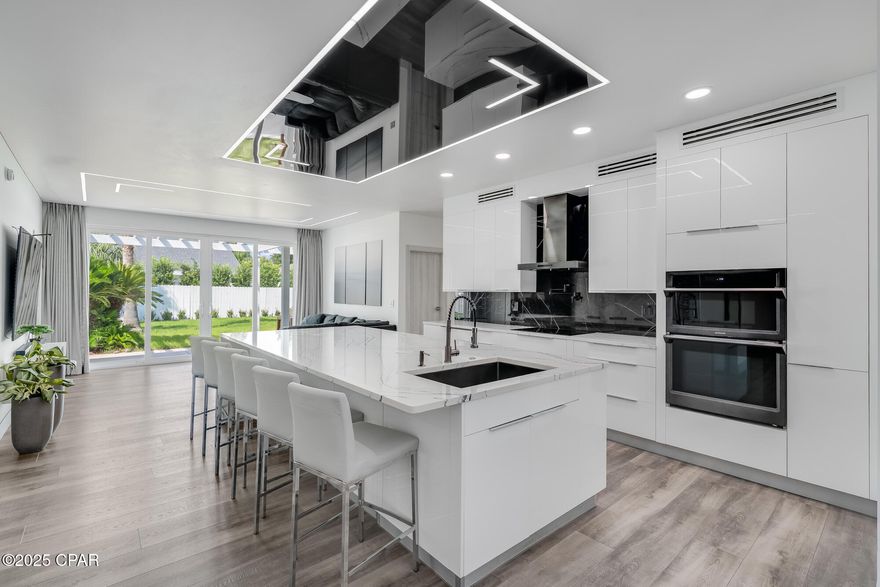 Discover the perfect blend of contemporary luxury and coastal comfort in this beautifully renovated home, ideally located in the highly desirable Palmetto Trace neighborhood. Just minutes from Pier Park, across the street from TopGolf, and a quick drive to the new hospital, this property offers both convenience and style.

Inside, the open-concept living area is bright and airy, featuring sleek recessed LED ceiling lighting, a spacious sectional, and floor-to-ceiling sliding glass doors that frame views of your private backyard oasis. The gourmet kitchen is a showstopper, boasting high-gloss cabinetry, a quartz waterfall island with seating, premium appliances, and a striking black-marble backsplash—perfect for casual dining or entertaining.

The primary suite is a true retreat, complete with a spa-inspired bathroom featuring heated floors, a towel warmer, LED-lit mirrors, dual sinks, a rainfall shower, and a freestanding soaking tub. The large walk-in closet is equipped with custom organizers to keep everything perfectly in place.

Step outside to a fully fenced backyard with lush tropical landscaping, a covered pergola patio for outdoor dining, and a sparkling saltwater pool—your own private escape. Lawn care and pool service are included, so you can spend more time enjoying the Florida sunshine.

Palmetto Trace is known for its tree-lined streets, pedestrian walkways, and two inviting community pools, adding to the neighborhood's charm and livability. With beaches, shopping, dining, and entertainment just moments away, this home offers the ultimate Panama City Beach lifestyle.